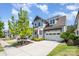 Charming two-story home with a well-manicured lawn, a covered porch, and an attached two-car garage at 376 Sensibility Cir # 8, Fort Mill, SC 29708