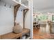 Entryway with a wooden bench, hooks, and a view into the dining and living area at 376 Sensibility Cir # 8, Fort Mill, SC 29708