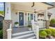 Inviting front porch with gray steps, fan, white railing, seating, and beautifully landscaped yard at 376 Sensibility Cir # 8, Fort Mill, SC 29708
