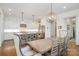 Bright kitchen featuring white cabinets, a gray island with seating, and a stainless steel refrigerator at 376 Sensibility Cir # 8, Fort Mill, SC 29708