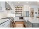 Modern kitchen with stainless steel appliances, open shelving, gas range, and farmhouse sink at 376 Sensibility Cir # 8, Fort Mill, SC 29708