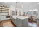 Spacious kitchen with white cabinets, a large island, farmhouse sink, and stainless appliances at 376 Sensibility Cir # 8, Fort Mill, SC 29708