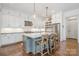 Modern kitchen with white cabinets, stainless steel appliances, and island with bar seating at 376 Sensibility Cir # 8, Fort Mill, SC 29708