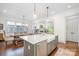 Bright and open kitchen featuring a large island with a farmhouse sink and stainless steel appliances at 376 Sensibility Cir # 8, Fort Mill, SC 29708