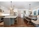 Open concept kitchen featuring white cabinets, a marble island, and stainless steel appliances, adjacent to the dining area at 376 Sensibility Cir # 8, Fort Mill, SC 29708