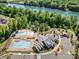 Aerial view showcasing a community pool, splashpad, park, clubhouse, and parking for resident enjoyment at 376 Sensibility Cir # 8, Fort Mill, SC 29708