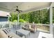 Spacious covered porch with ample seating, a ceiling fan, and a view of the backyard trees at 376 Sensibility Cir # 8, Fort Mill, SC 29708