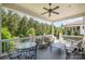 Spacious covered porch with ample seating, a ceiling fan, and a view of the backyard trees at 376 Sensibility Cir # 8, Fort Mill, SC 29708