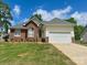 Attractive brick and vinyl home featuring a well-kept lawn and a two-car garage at 3776 Kennedy Rd, Gastonia, NC 28056