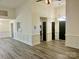 An open-concept living room featuring wood-look floors and wainscoting details at 3776 Kennedy Rd, Gastonia, NC 28056
