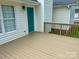 Close up of wooden deck overlooking the backyard and an entry door to the house at 3776 Kennedy Rd, Gastonia, NC 28056