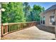 Large wooden back deck with wooden railing and lush surrounding trees at 397 Fischer Rd, Fort Mill, SC 29715