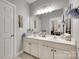 This bathroom features double sinks, white cabinets, and a large mirror at 397 Fischer Rd, Fort Mill, SC 29715