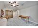 Bonus room featuring a ceiling fan, an accent wall, a sofa, and a wooden table at 397 Fischer Rd, Fort Mill, SC 29715