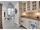 Butler pantry with granite countertops, white cabinets and access to the kitchen and dining area at 397 Fischer Rd, Fort Mill, SC 29715