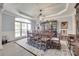 Elegant dining room with a large window, long wooden table, and decorative accents at 397 Fischer Rd, Fort Mill, SC 29715