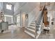 Grand foyer featuring a staircase with iron spindles, hardwood floors, and high ceilings at 397 Fischer Rd, Fort Mill, SC 29715