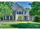 Beautiful two-story home with stone accents, black shutters and lush green lawn at 397 Fischer Rd, Fort Mill, SC 29715
