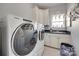 Laundry room featuring new Whirlpool washer and dryer and white cabinetry with a sink at 397 Fischer Rd, Fort Mill, SC 29715