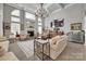 Grand living room featuring a fireplace, a decorative chandelier, and bright natural light from large windows at 397 Fischer Rd, Fort Mill, SC 29715