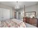 This main bedroom features a four-poster bed, a chandelier, and neutral-colored walls at 397 Fischer Rd, Fort Mill, SC 29715