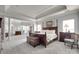 Spacious main bedroom with tray ceilings, a four-poster bed, and ample seating area at 397 Fischer Rd, Fort Mill, SC 29715