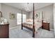 This main bedroom features a canopy bed with a floral comforter set and a chandelier at 397 Fischer Rd, Fort Mill, SC 29715