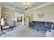 Cozy sitting room with a blue velvet couch, decorative furniture and a bright window at 397 Fischer Rd, Fort Mill, SC 29715