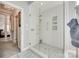 Luxurious walk-in shower with glass door, dual shower heads, and stone pebble floor at 397 Fischer Rd, Fort Mill, SC 29715