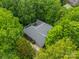 Aerial view of a brick home nestled among lush trees, offering a serene and private setting at 4033 Weddington Manor Ct, Matthews, NC 28104