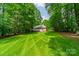 Beautiful, verdant backyard view of the property, surrounded by mature trees at 4033 Weddington Manor Ct, Matthews, NC 28104