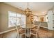 Dining area with backyard view, stylish chandelier, and easy kitchen access at 4033 Weddington Manor Ct, Matthews, NC 28104
