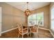 Cozy dining area with unique chandelier and backyard view through the window at 4033 Weddington Manor Ct, Matthews, NC 28104