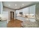 Well-lit kitchen with white cabinets, granite countertops, and stainless steel appliances at 4033 Weddington Manor Ct, Matthews, NC 28104