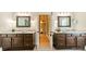This main bathroom features a double vanity with marble countertops and matching framed mirrors at 4033 Weddington Manor Ct, Matthews, NC 28104