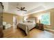 This main bedroom features a tray ceiling, hardwood floors, and lots of natural light at 4033 Weddington Manor Ct, Matthews, NC 28104