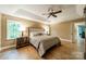 This is a spacious main bedroom with hardwood floors, a ceiling fan, and a neutral color palette at 4033 Weddington Manor Ct, Matthews, NC 28104