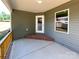Covered porch featuring concrete base, wood railing, and ample natural light at 4049 Fincher Rd # 3, Matthews, NC 28104