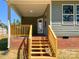 Covered porch featuring wood steps, railing, and access to the backyard at 4049 Fincher Rd # 3, Matthews, NC 28104