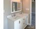 Bathroom featuring a double sink vanity with white cabinets, granite countertop, and a framed mirror at 4049 Fincher Rd # 3, Matthews, NC 28104