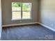 Bedroom featuring neutral walls, gray carpet, a large window, and ample natural light at 4049 Fincher Rd # 3, Matthews, NC 28104