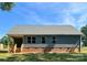 Rear view of home with covered porch and well-maintained lawn, showcasing the backyard at 4049 Fincher Rd # 3, Matthews, NC 28104