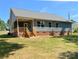 Charming home exterior with covered porch, showcasing a well-maintained lawn and classic design elements at 4049 Fincher Rd # 3, Matthews, NC 28104