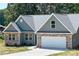 Craftsman style home with green siding, stone accents, attached two-car garage, and a concrete driveway at 4049 Fincher Rd # 3, Matthews, NC 28104