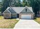 Craftsman style home with green siding, stone accents, attached two-car garage, and a concrete driveway at 4049 Fincher Rd # 3, Matthews, NC 28104