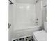 Bathroom featuring white shower-tub and patterned flooring at 4132 Kenton Glenn Nw Ct, Concord, NC 28027