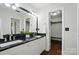 Bathroom showcasing dual sinks, granite counters, modern lighting, and a walk-in closet entrance at 4132 Kenton Glenn Nw Ct, Concord, NC 28027