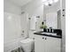 Bathroom featuring black granite countertops, white cabinetry, and a shower-tub at 4132 Kenton Glenn Nw Ct, Concord, NC 28027