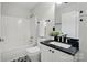 Bathroom featuring black granite countertops, white cabinetry, and a shower-tub at 4132 Kenton Glenn Nw Ct, Concord, NC 28027