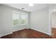 This is a bright bedroom with hardwood floors and natural light streaming through the window at 4132 Kenton Glenn Nw Ct, Concord, NC 28027